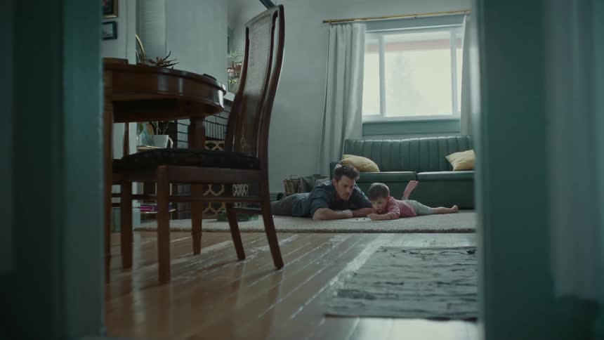 A father and son play a board game