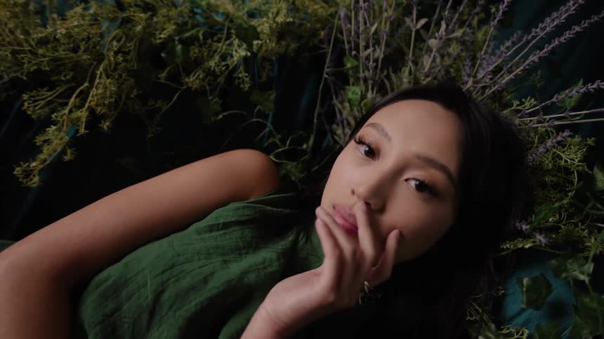 A woman is laying on a bunch of lavender