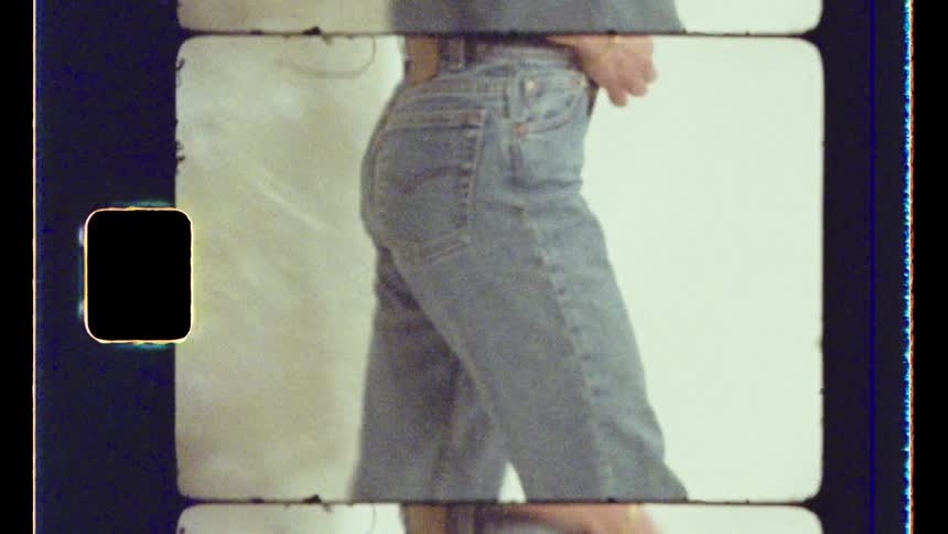 Closeup of a woman putting on jeans in a studio