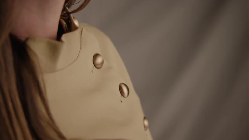 Closeup of a model holding her own hair with her fingers