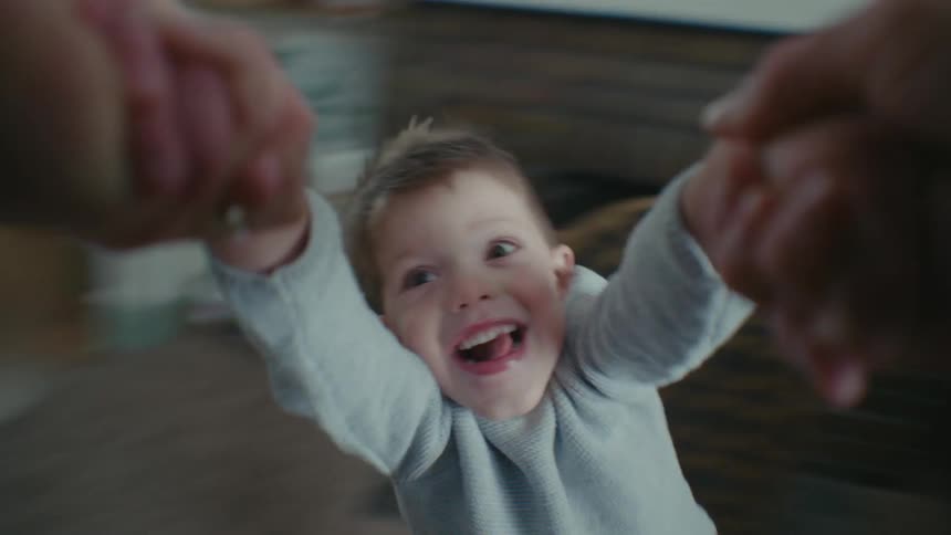 Point of view of hands holding the hands of a child and spinning them around