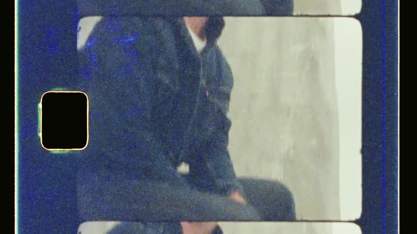 A man seated on a chair indoor while looking up
