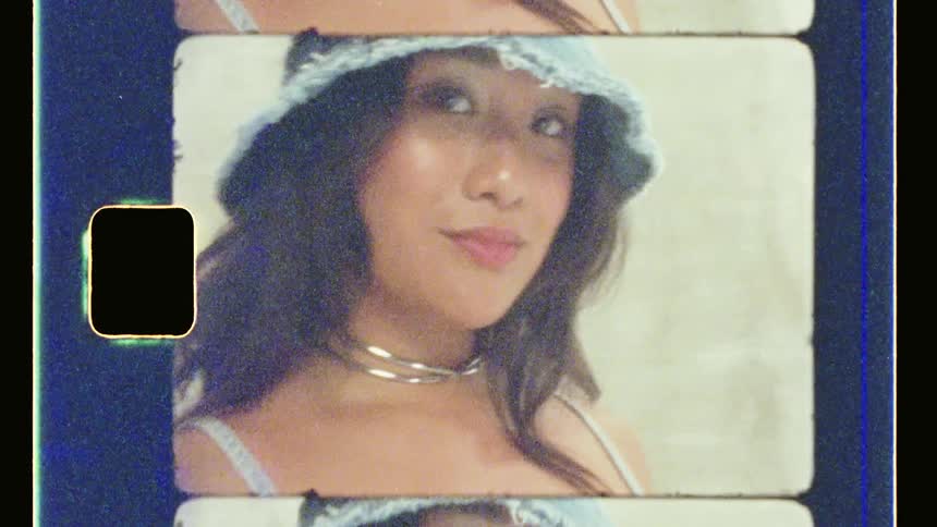 A woman wearing a hat smiles