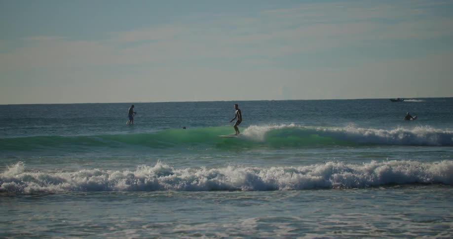 Man surfing a small wave on a summer day