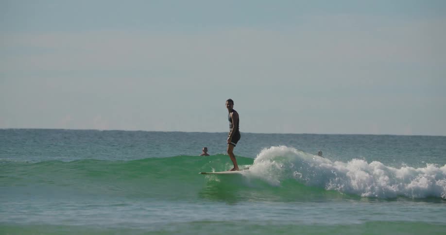 A surfer rides a wave until it subsides