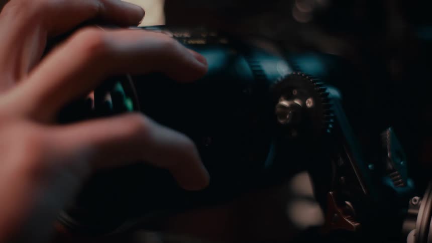 A view of a person taking a lens off a camera