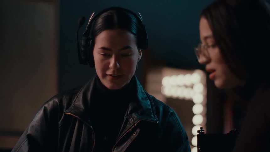 Two people have a conversation in a studio