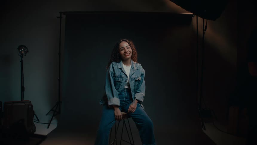 A model smiles as she poses in the studio