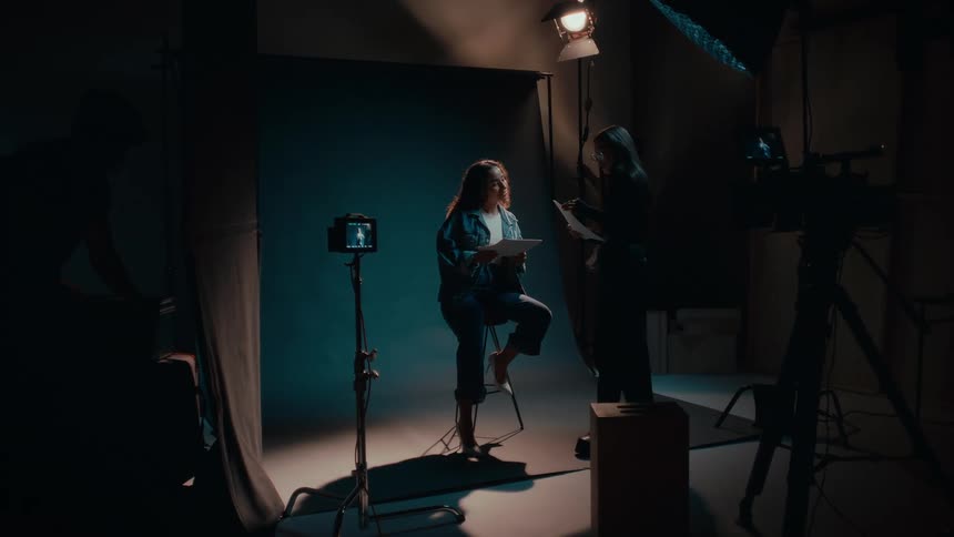 A woman explains to another woman in a studio