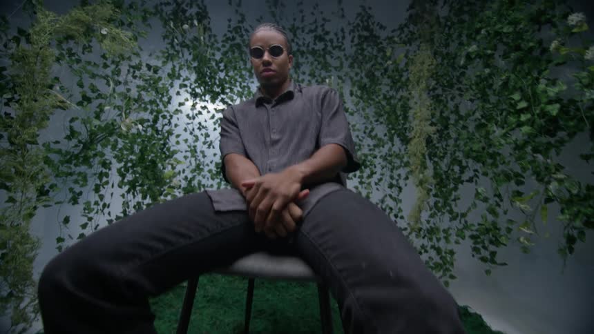 Model sitting in a chair posing in a fashionable way