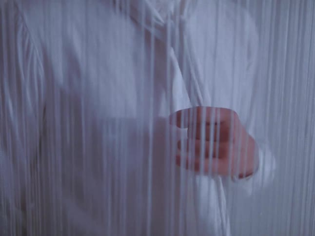 Scarf detail behind a string curtain