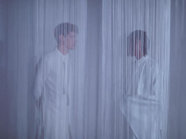 Two models looking at each other face to face in fashionable white clothes