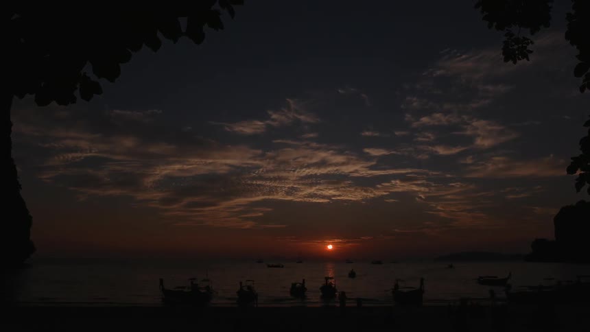 Beach-goers enjoy the beach as the sunsets
