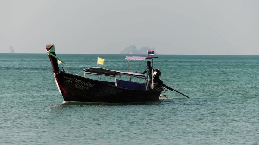 Person driving a boat on the sea on windy day