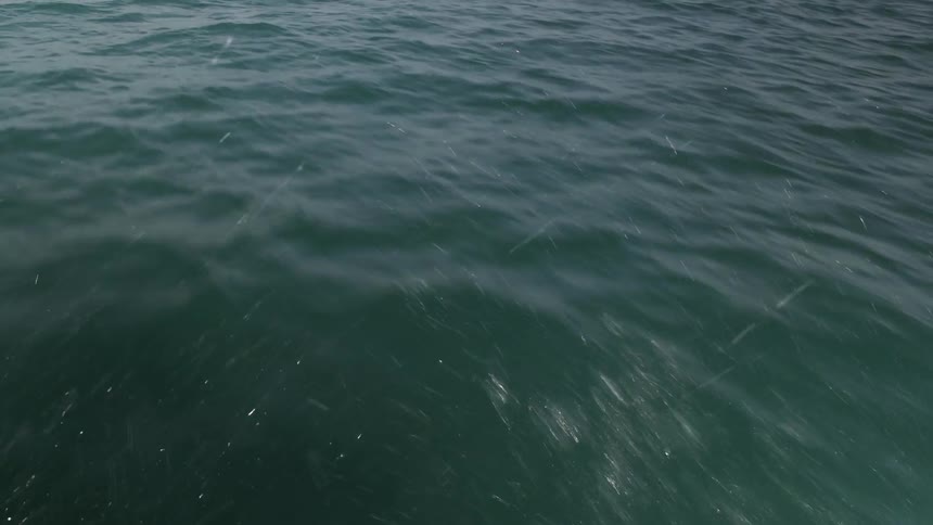 Object skims a body of water traveling view