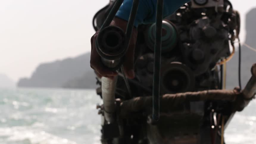 A person steers a boat through a body of water