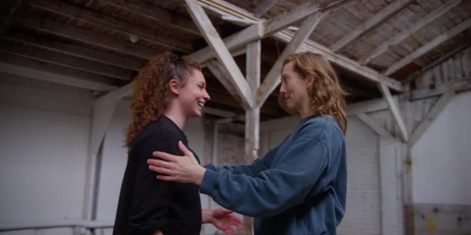 Two happy friends hugging and talking to each other