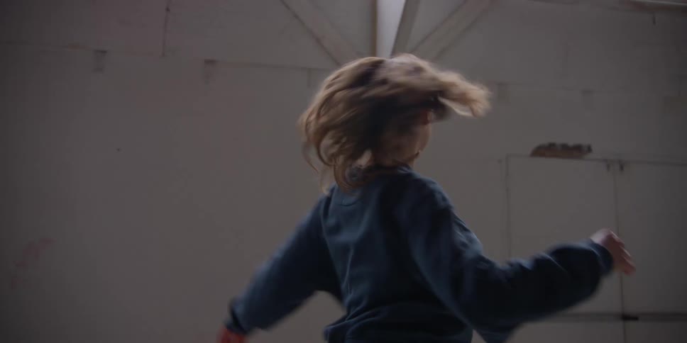 A woman shows dance moves to another dancer