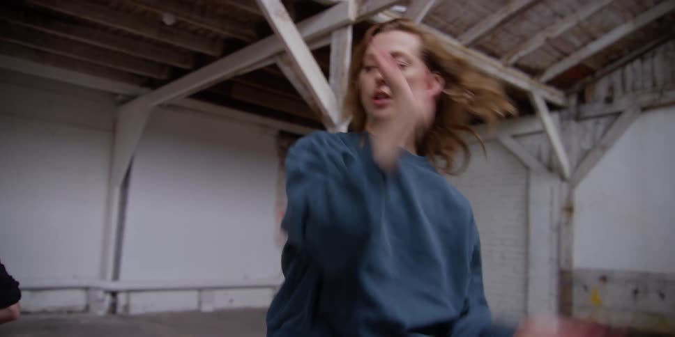 Two women in a room practicing a joint choreography
