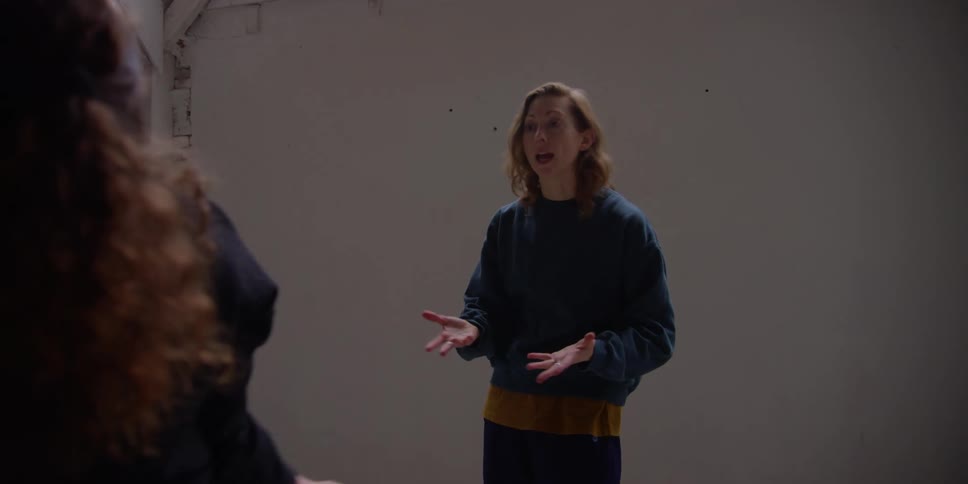Woman rehearsing a dance choreography with her colleague