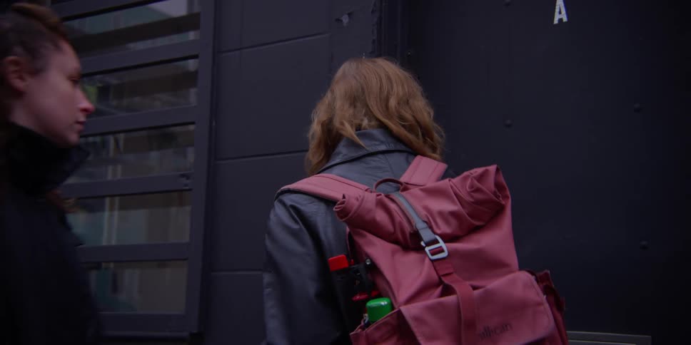 Women enter a city building during the cold day