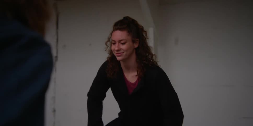 Woman balances on one foot while mimicking another womans pose