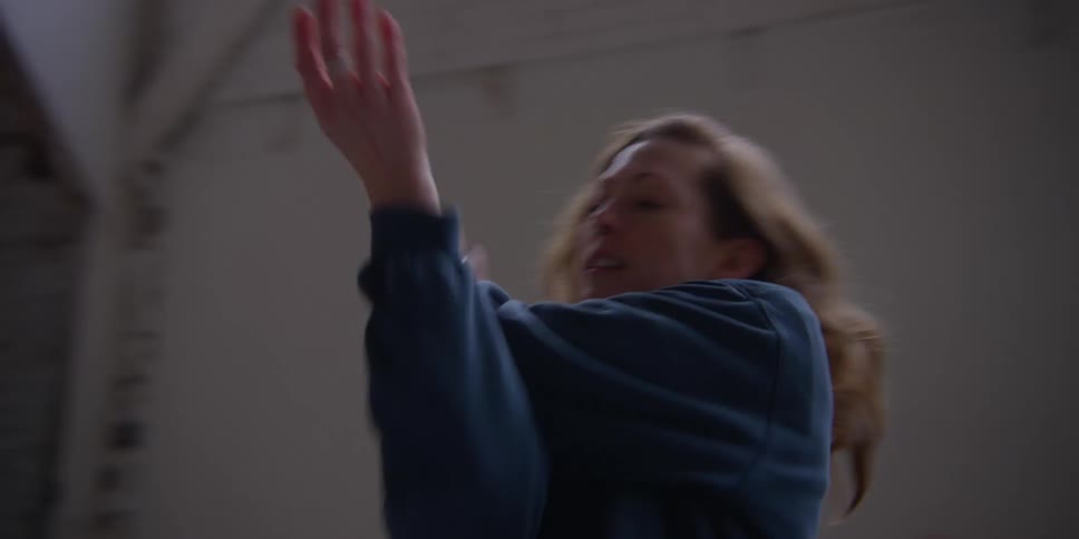 A woman dances in a room