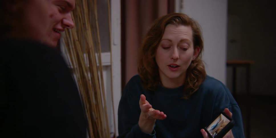 Group of friends watching a video on their cell phone debating me about