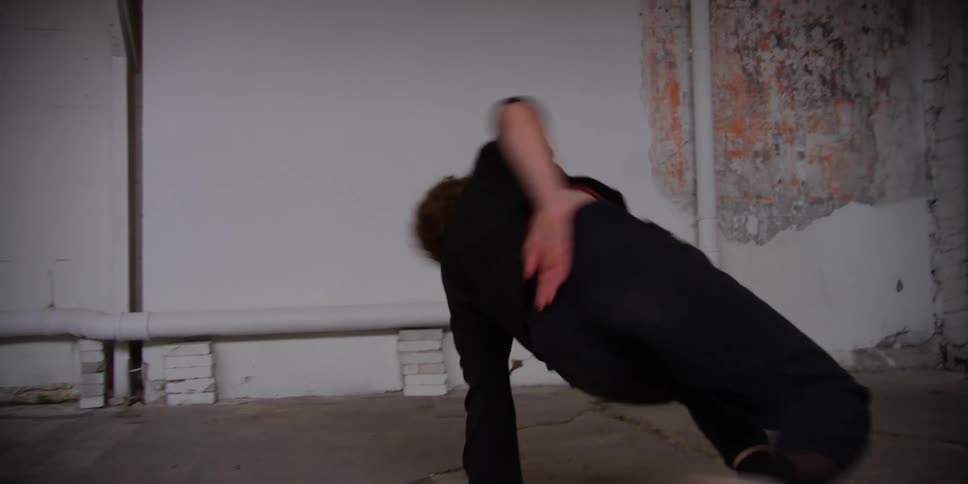 A woman does a flip and kick