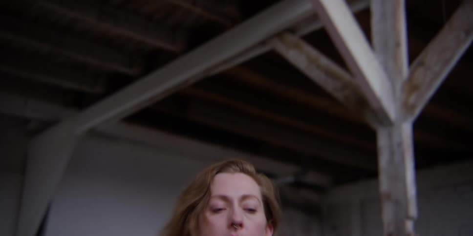 A woman doing modern dance moves in a room