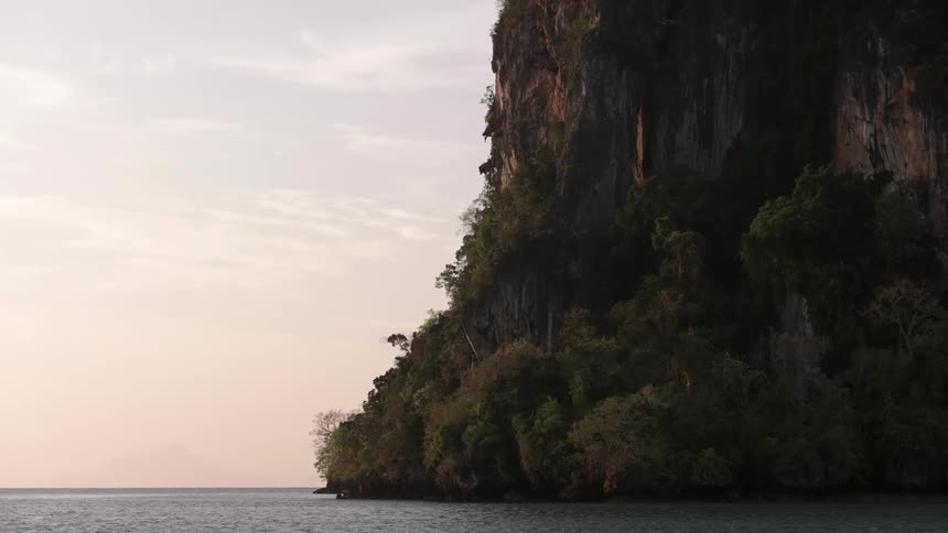 Green covered mountainside at a sea's edge