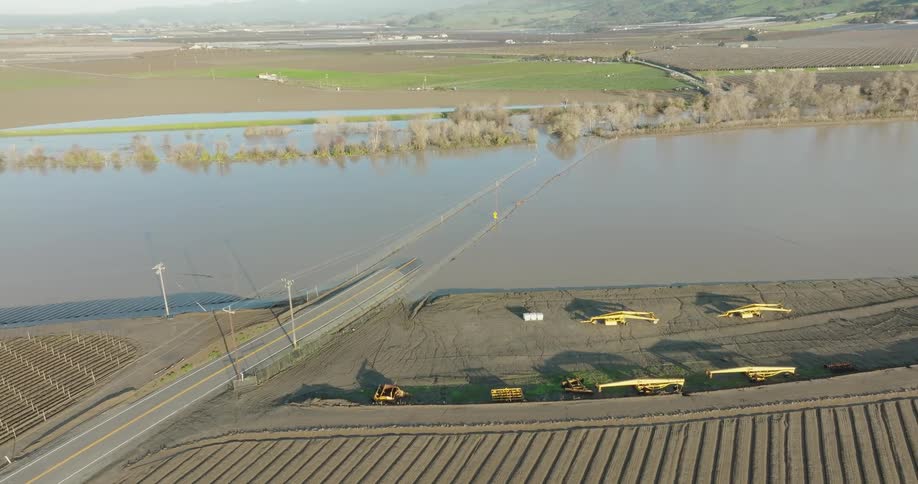 A flooded road in a rural town during the day