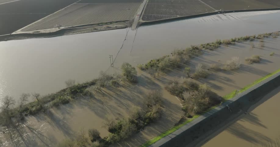 Aerial panorama of a lake that covered a lawn next to agricultural fields
