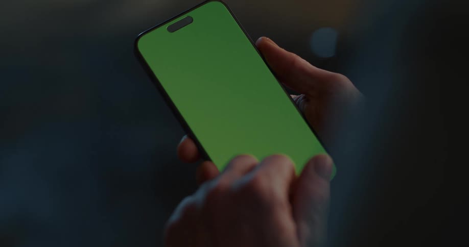Hands of a person using a cell phone