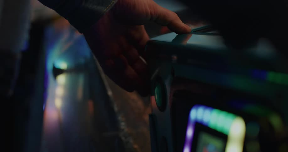 A person presses the button in the arcade