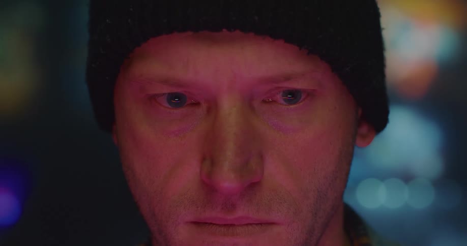 Mans eyes reflects computer screen he is viewing