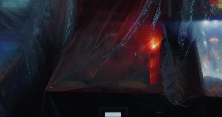 A pinball machine lights up underneath plastic