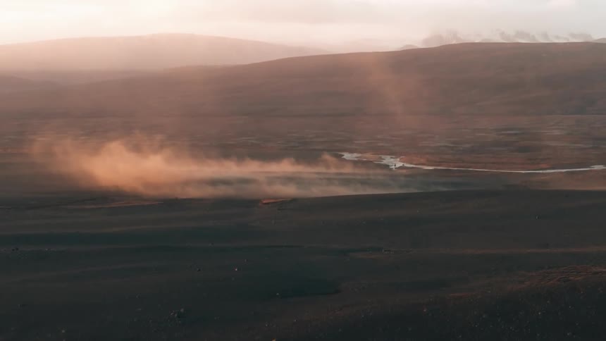 Aerial of a desert with a small river during a hot summer day