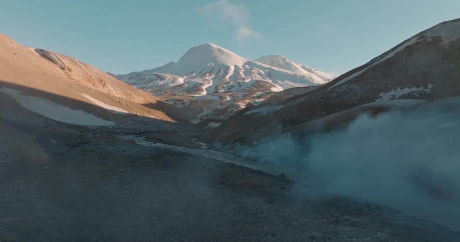 A clip of a smoke at the river bank of an ice mountain