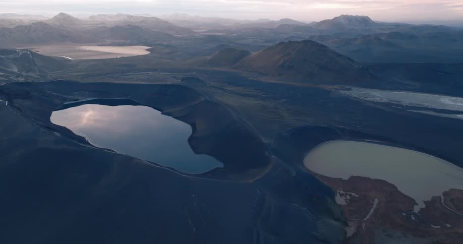 Crater landscape with water reflecting the morning sky