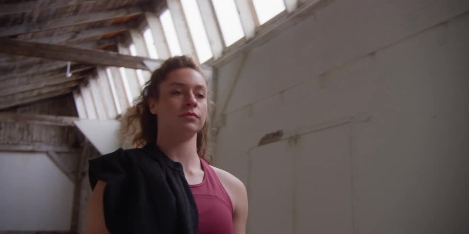 Closeup of a young womans face walking in a warehouse