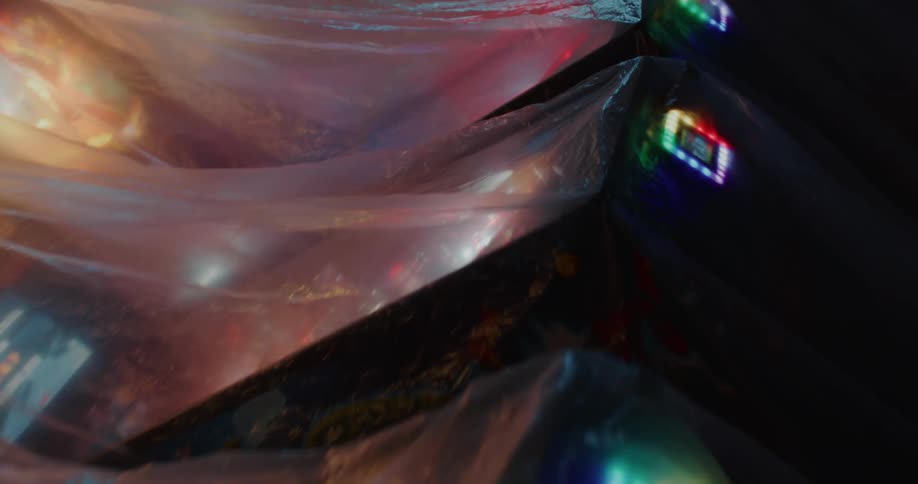 The pinball machines are covered in plastic sheets
