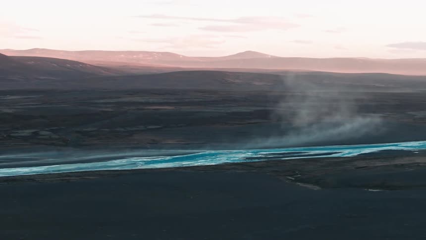 A misty river on a vast landscape at sunset