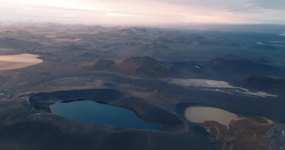 Aerial panorama of a landscape with mountains lakes and plateaus on a purple sky morning
