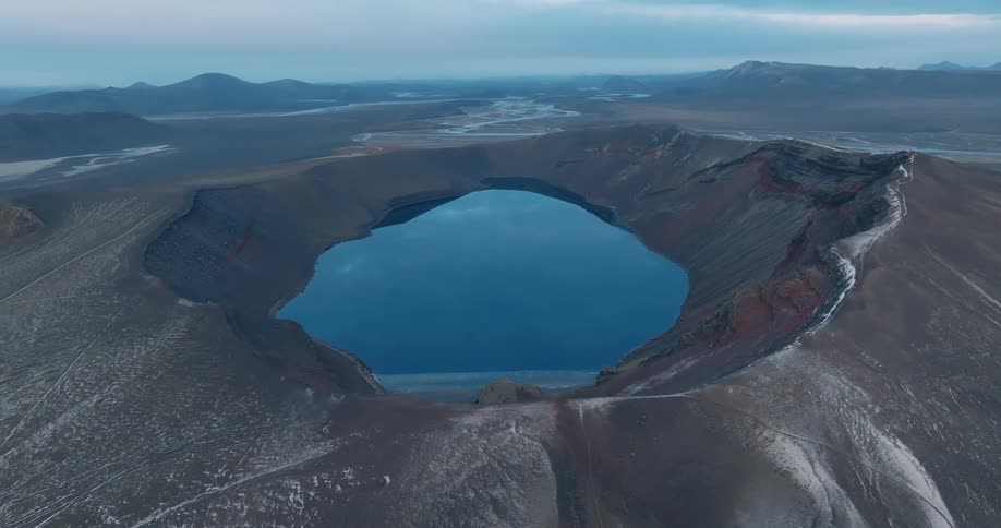 A lake sits in a volcanic crater