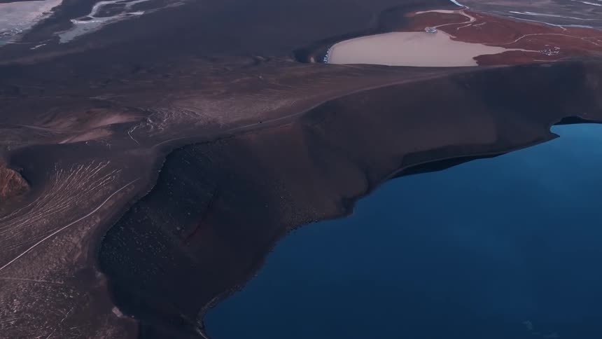 Aerial view of a crater lake on a barren landscape