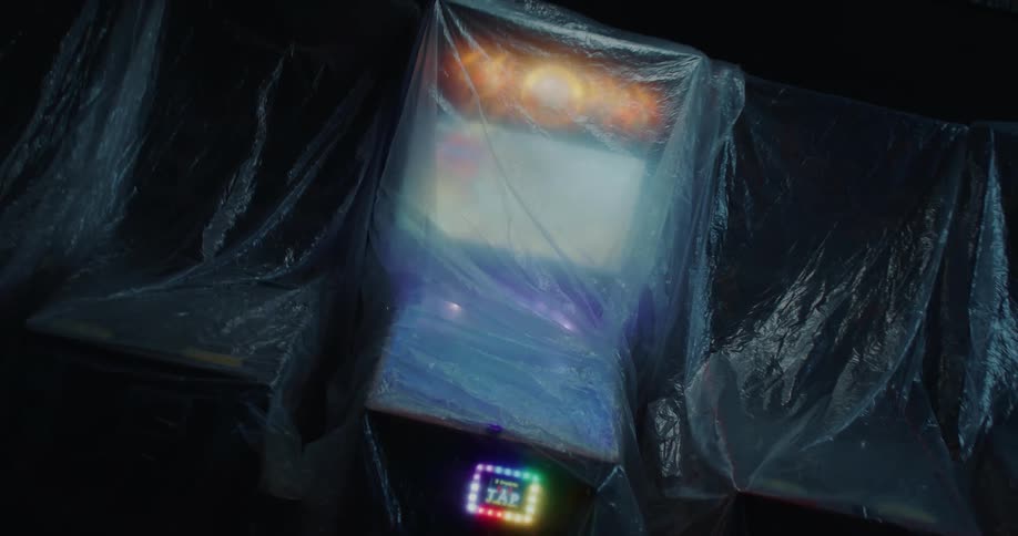 Colorful pinball machine wrapped under clear plastic