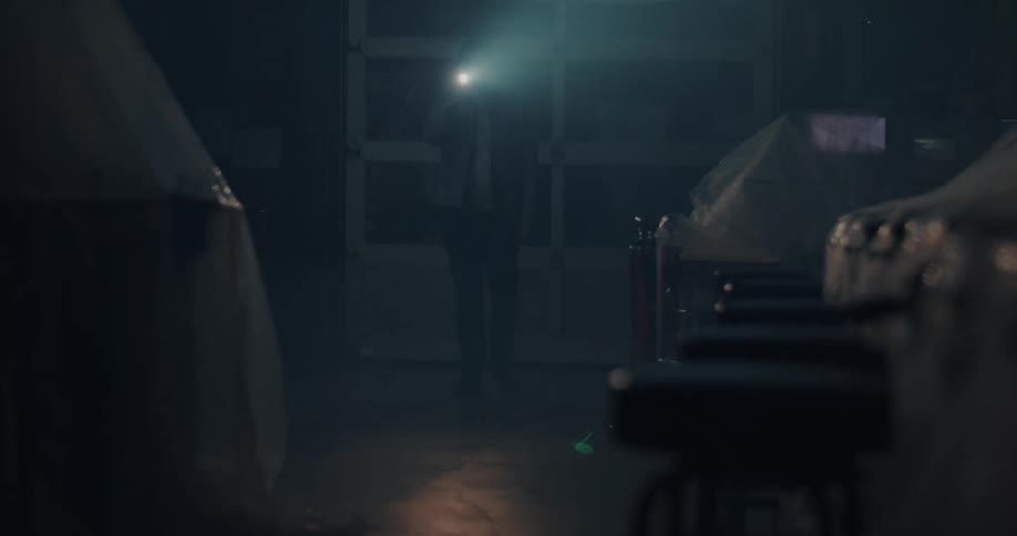 Man entering a dark room with a flashlight and carrying out the check
