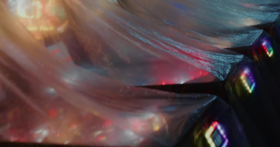 Rows of pinball machines light up under plastic covers