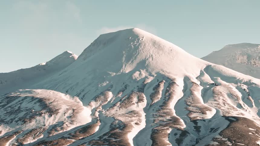 Landscape of mountains covered in snow on a sunny day